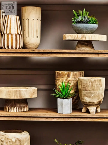 A rustic wooden pedestal with three textured tiers supporting the arlo natural engraved round bowl