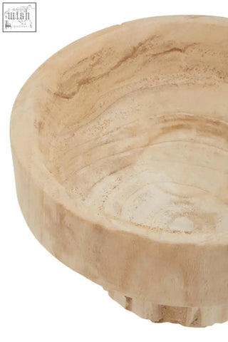 A rustic light beige wooden engraved round bowl with natural hand carved texture and visible grain patterns