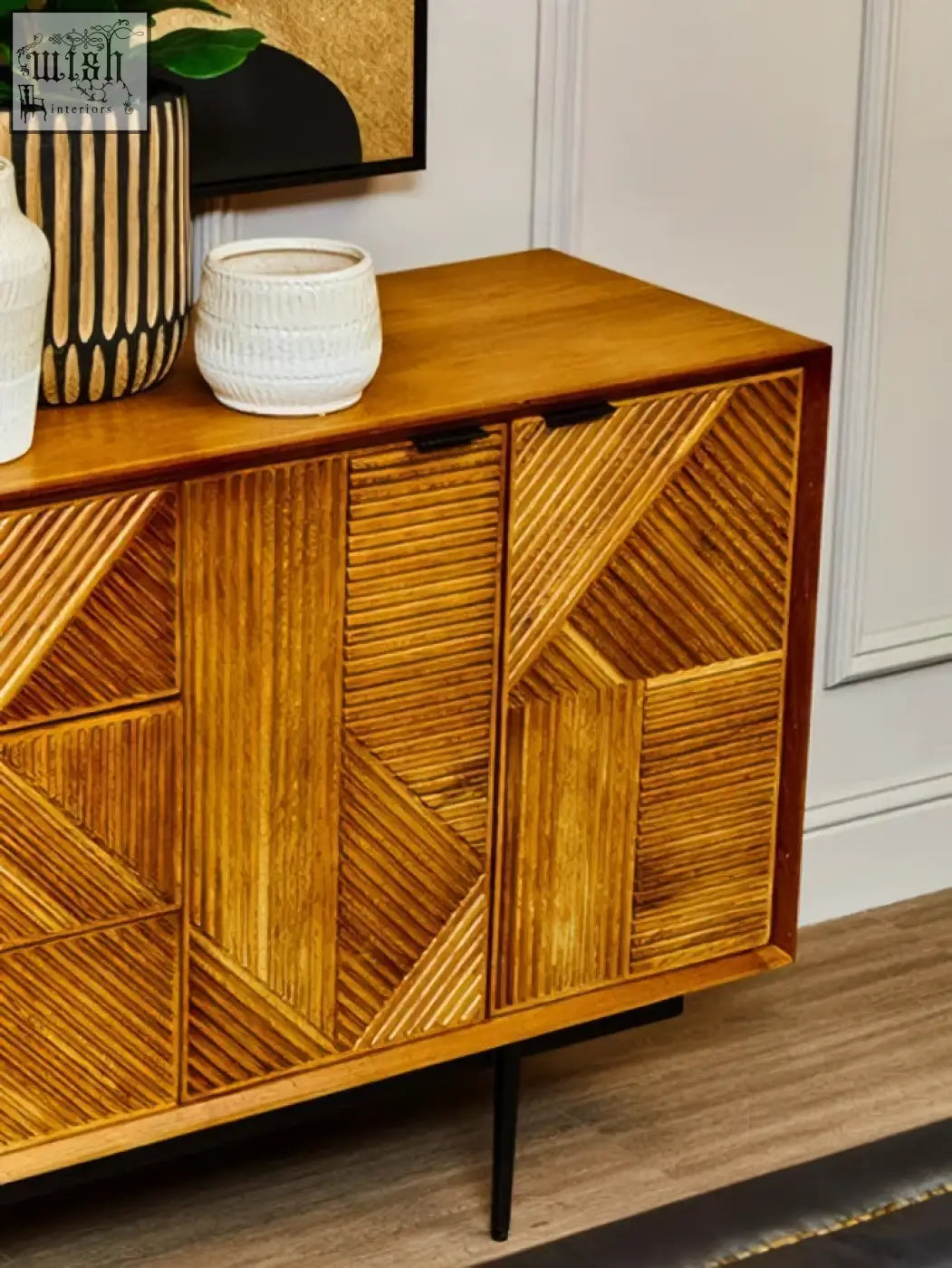 Wooden sideboard with small engraved natural woven-patterned doors in warm honey-toned finish