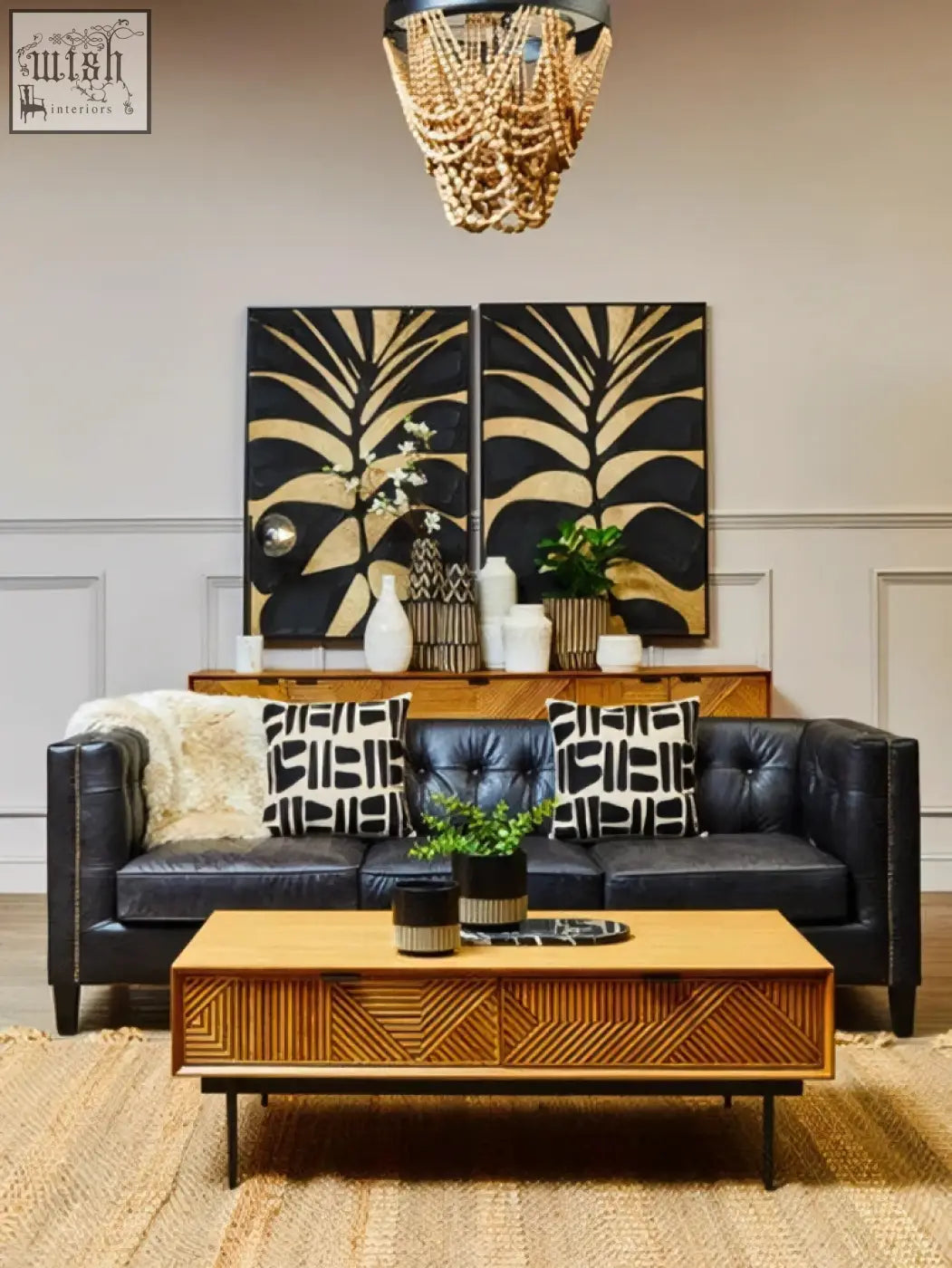 Black leather tufted sofa with geometric pillows next to a small engraved natural and black planter