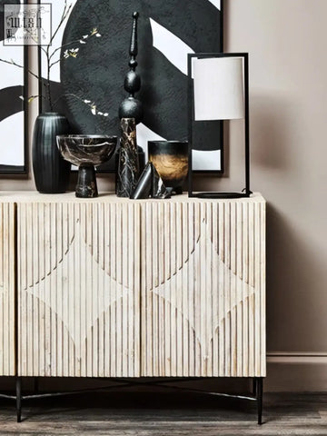 Beige wooden sideboard with vertical slats and diamond-shaped cutouts paired with arlo small black ombre planter