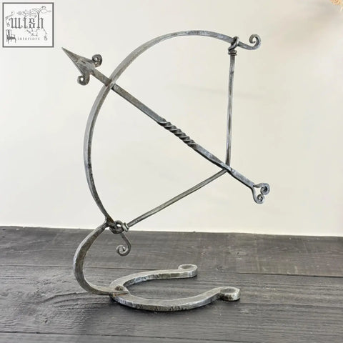 Forged iron armillary arrow sculpture with ornate scrollwork, solid iron with visible hammer marks, archer sculpture design