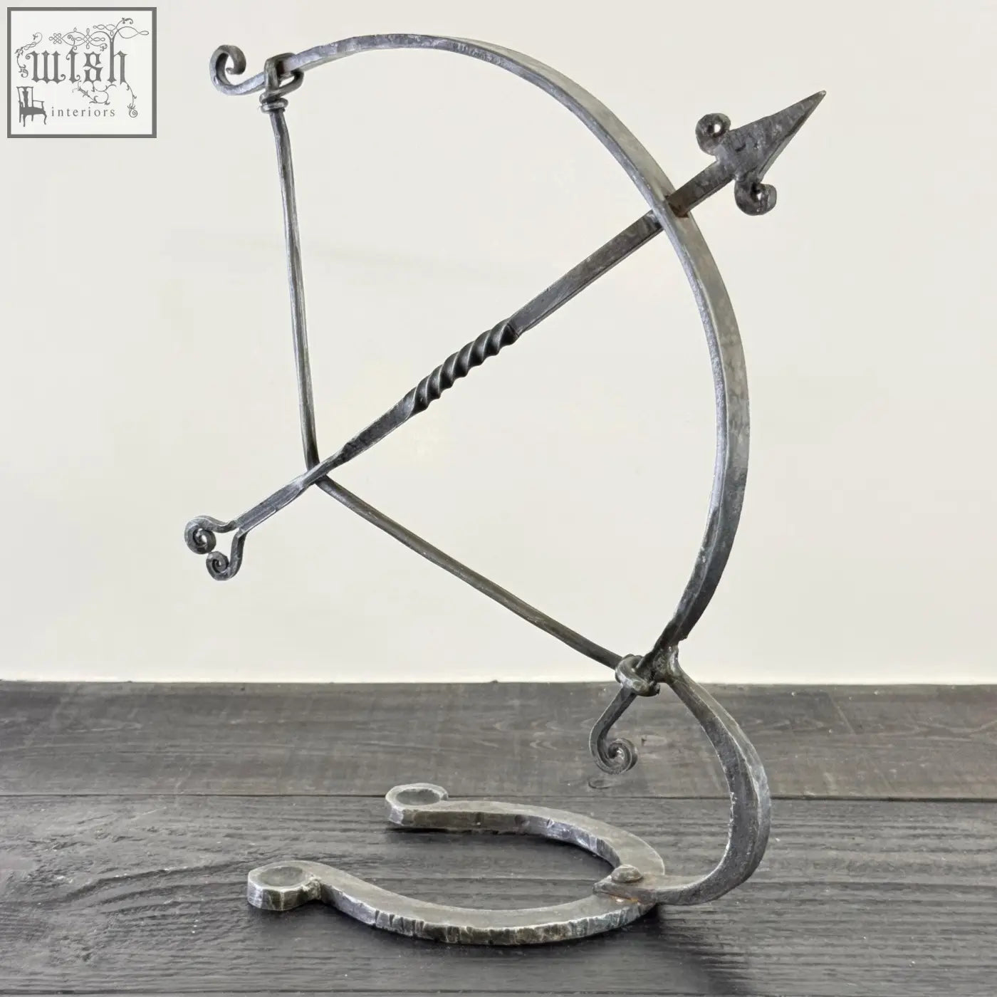 Solid iron archer sculpture with forged hammer marks and rustic finish armillary arrow wrought iron design