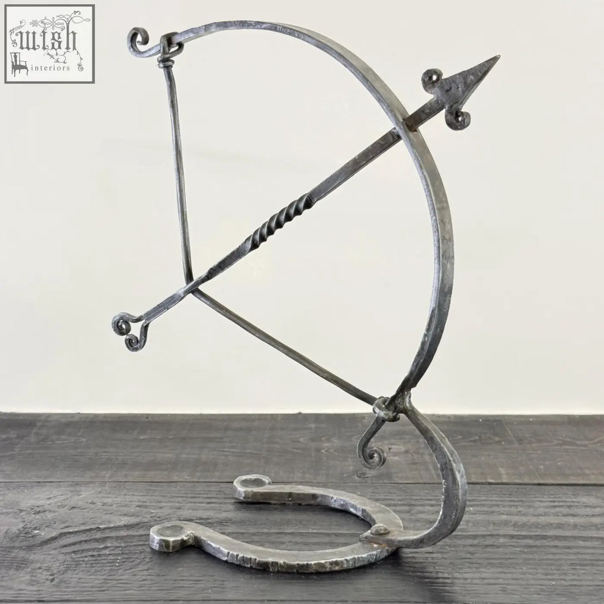 Solid iron archer sculpture with forged hammer marks and rustic finish armillary arrow wrought iron design