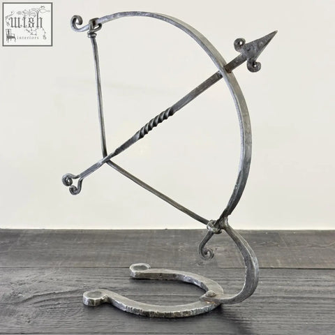 Solid iron archer sculpture with forged hammer marks and rustic finish armillary arrow wrought iron design