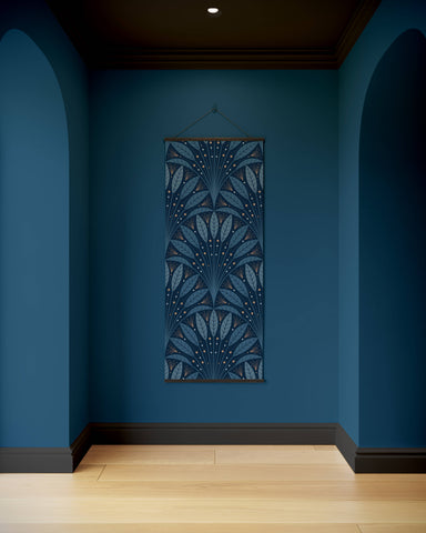 A vertical hanging tapestry with an intricate blue and white art deco leaf fan pattern framed by dark wood