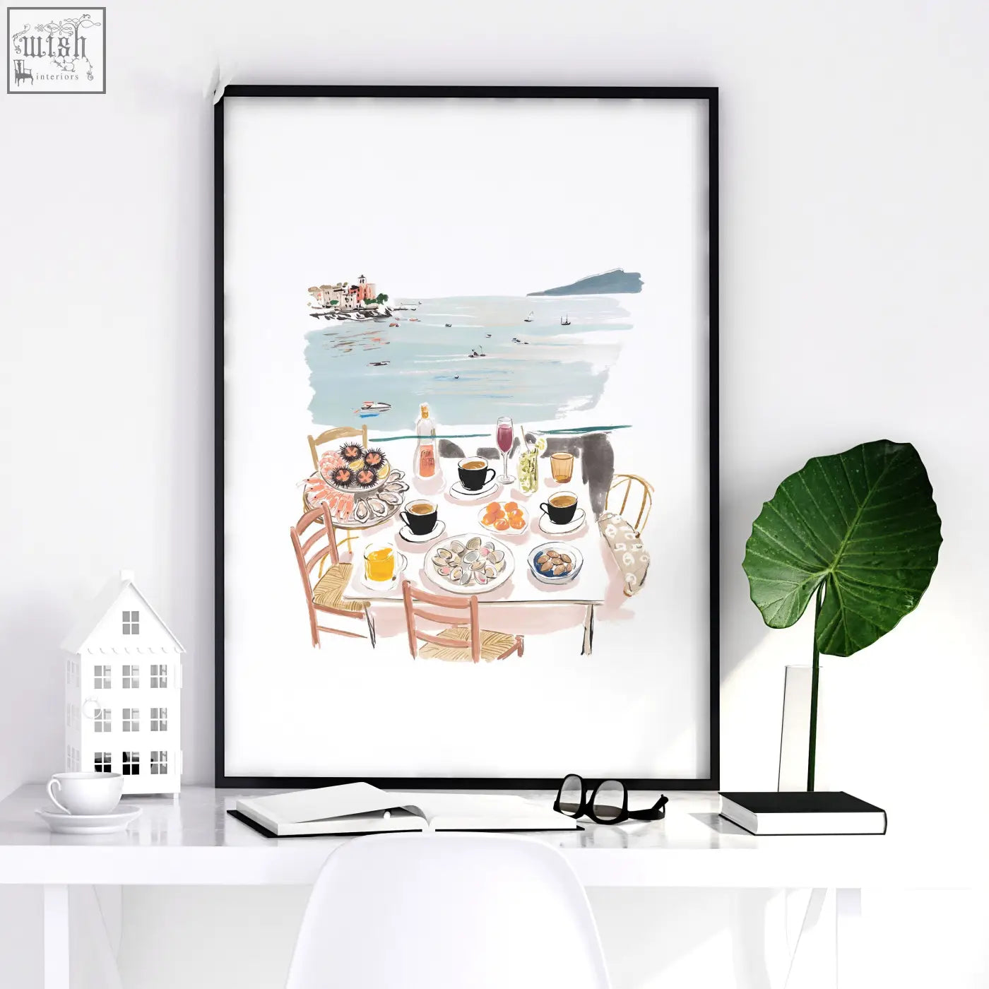 Black-framed art prints featuring a pastel mediterranean coastal dining scene in watercolor for office decor
