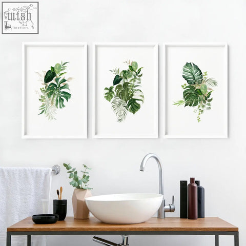 Three framed tropical wall prints with lush green leaves in white frames perfect for bathroom walls uk
