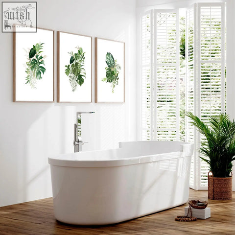 White freestanding bathtub with chrome faucet next to art for bathroom walls uk set of 3 tropical wall prints