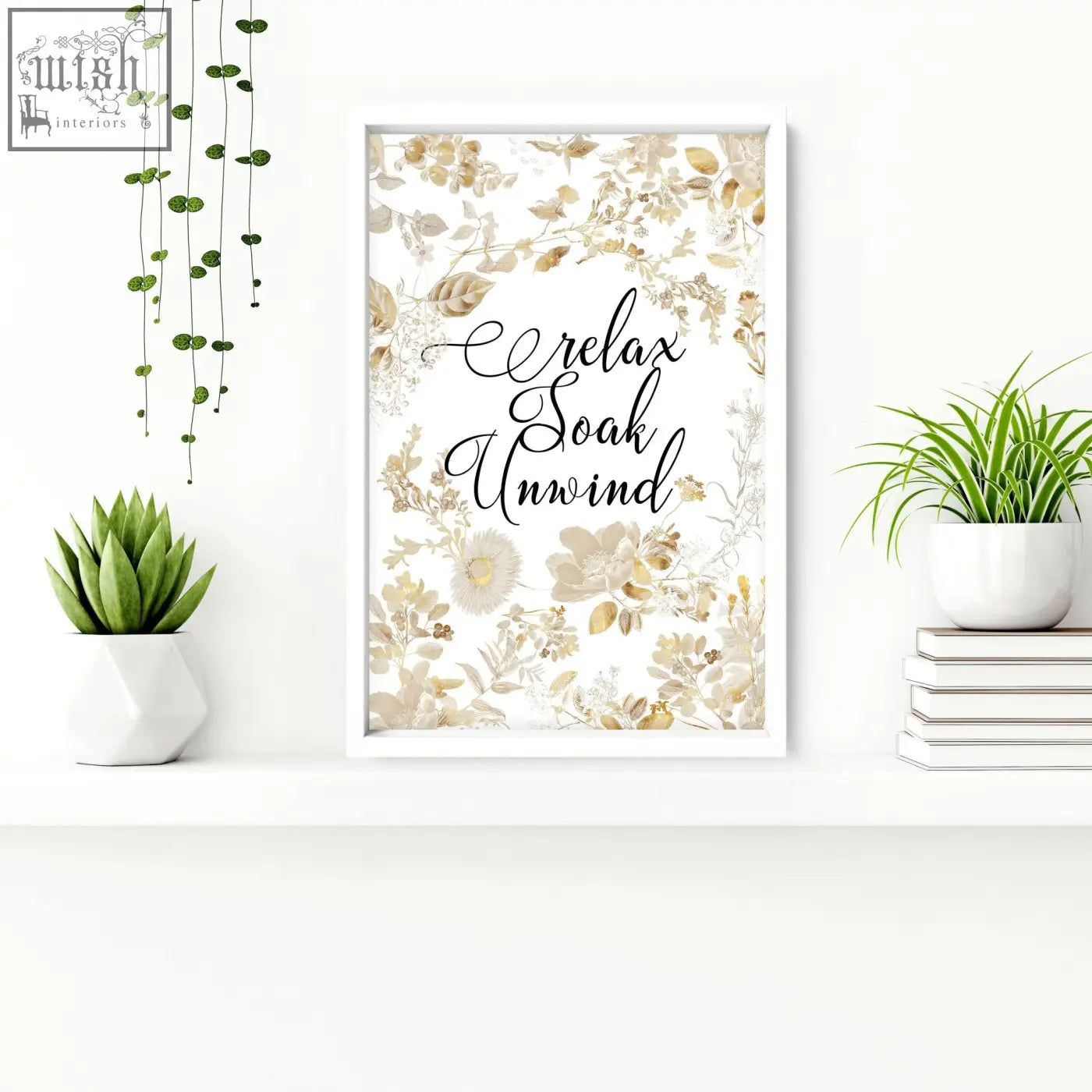 A framed wall art print with soft gold and cream floral design and relax soak unwind text for bathroom walls