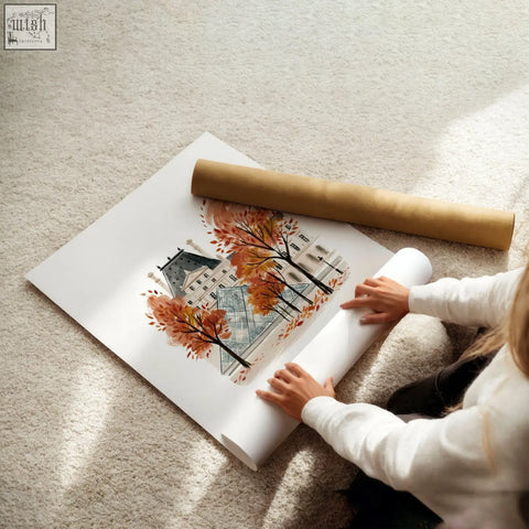 A rolled-up autumn paris travel wall art print on white paper with warm burgundy trees and une pause design