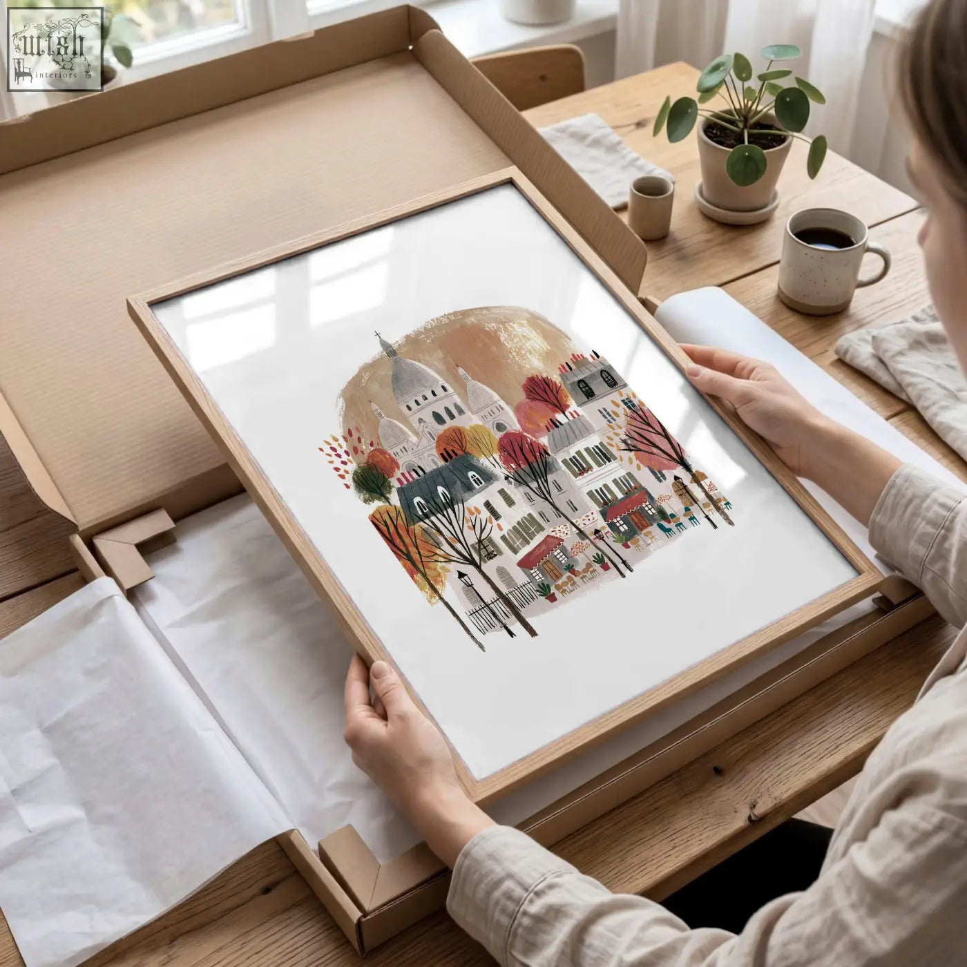 A framed watercolor autumn paris street scene with warm burgundy trees in a light wood frame for bedroom wall art
