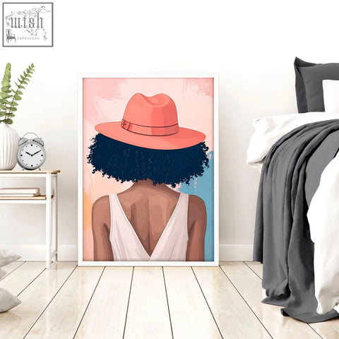 Framed wall art print of a boho woman with dark curls wearing a coral fedora and white top for bedroom decor