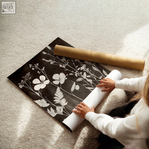 Black and white mink botanical dark floral wall art prints being unrolled for a living room wall or room wall decor
