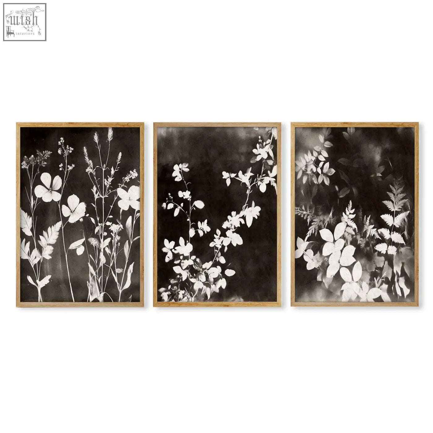 Set of three framed botanical prints with black and white floral silhouettes in light wood frames for living room wall decor