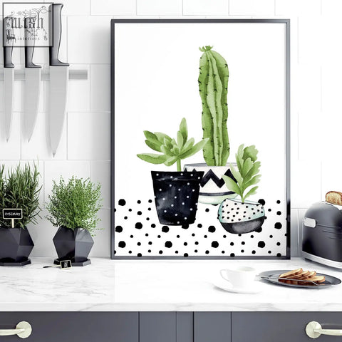 Black-framed wall art prints featuring green cactus and succulents in patterned pots for kitchen decor
