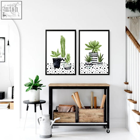 Two framed watercolor-style cactus art prints in patterned pots with black polka dot background perfect for kitchen wall art
