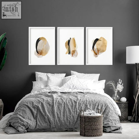 Set of three framed abstract art prints with gold black and beige brushstrokes perfect for modern bedroom decor