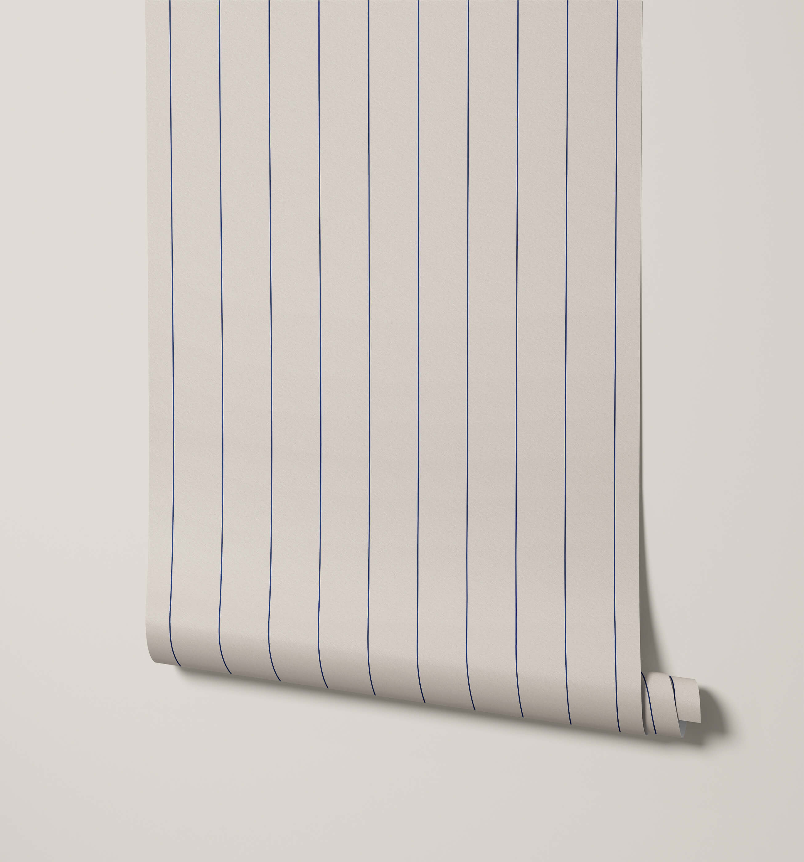 A roll of arthur minimal pinstripe wallpaper in cream with fine evenly spaced navy blue vertical stripes