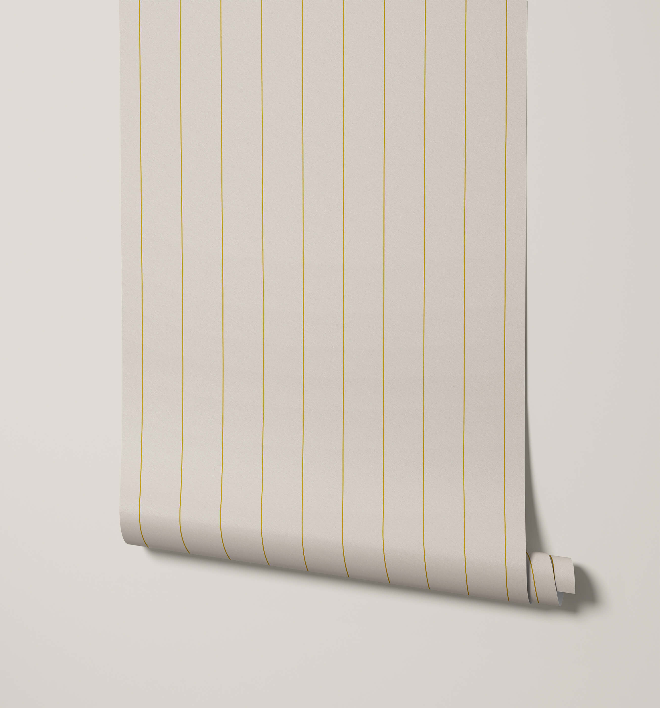 A roll of arthur minimal pinstripe wallpaper in off-white with delicate gold vertical stripes for a subtle look