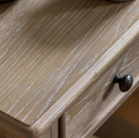 Artisan bedside drawer in light gray oak wood with a dark bronze knob for stylish bedroom storage