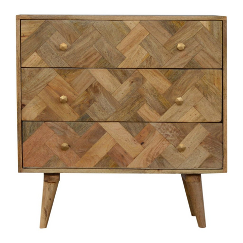 A rustic chest of drawers with three drawers and herringbone pattern made from solid mango wood with tapered legs