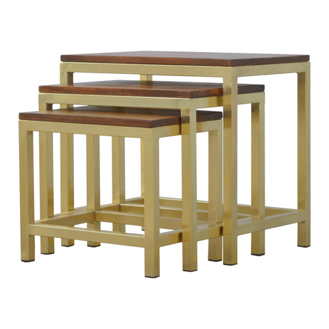 Set of three nested stool set with solid mango wood dark tops and chunky gold metal frames for artisan style