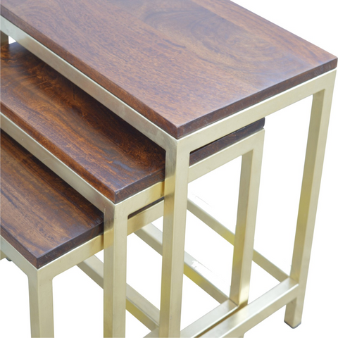 Set of three nested stool set with solid mango wood tops and gold-finished metal frames in dark wood color