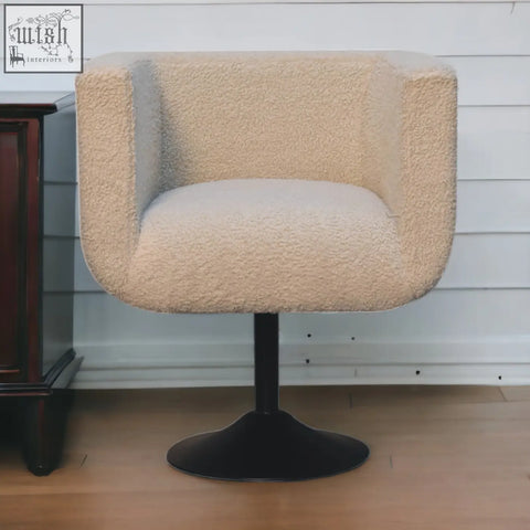 Cream boucle swivel chair with plush texture and sleek black pedestal base from Artisan Furniture mango wood collection