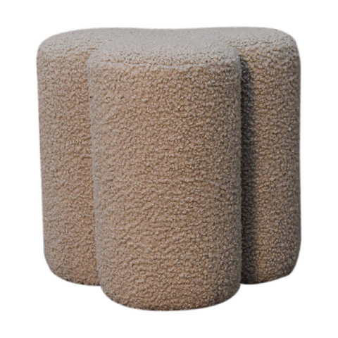 Beige mud boucle faux fur ottoman with soft textured surface and rounded shape in artisan furniture clover footstool style
