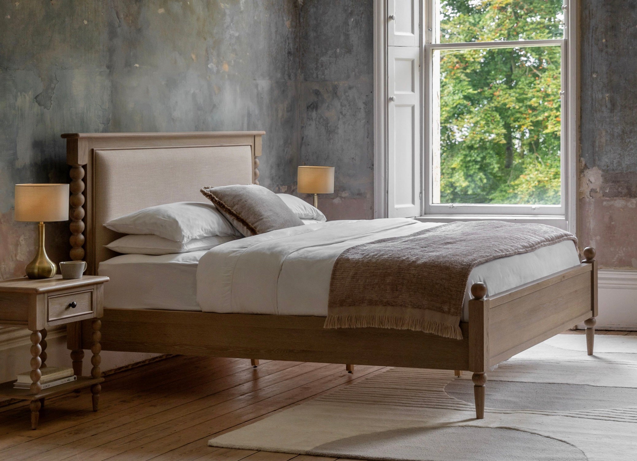 Artisan king size bed frame with rustic wooden slats and beige upholstered headboard and footboard king size bed