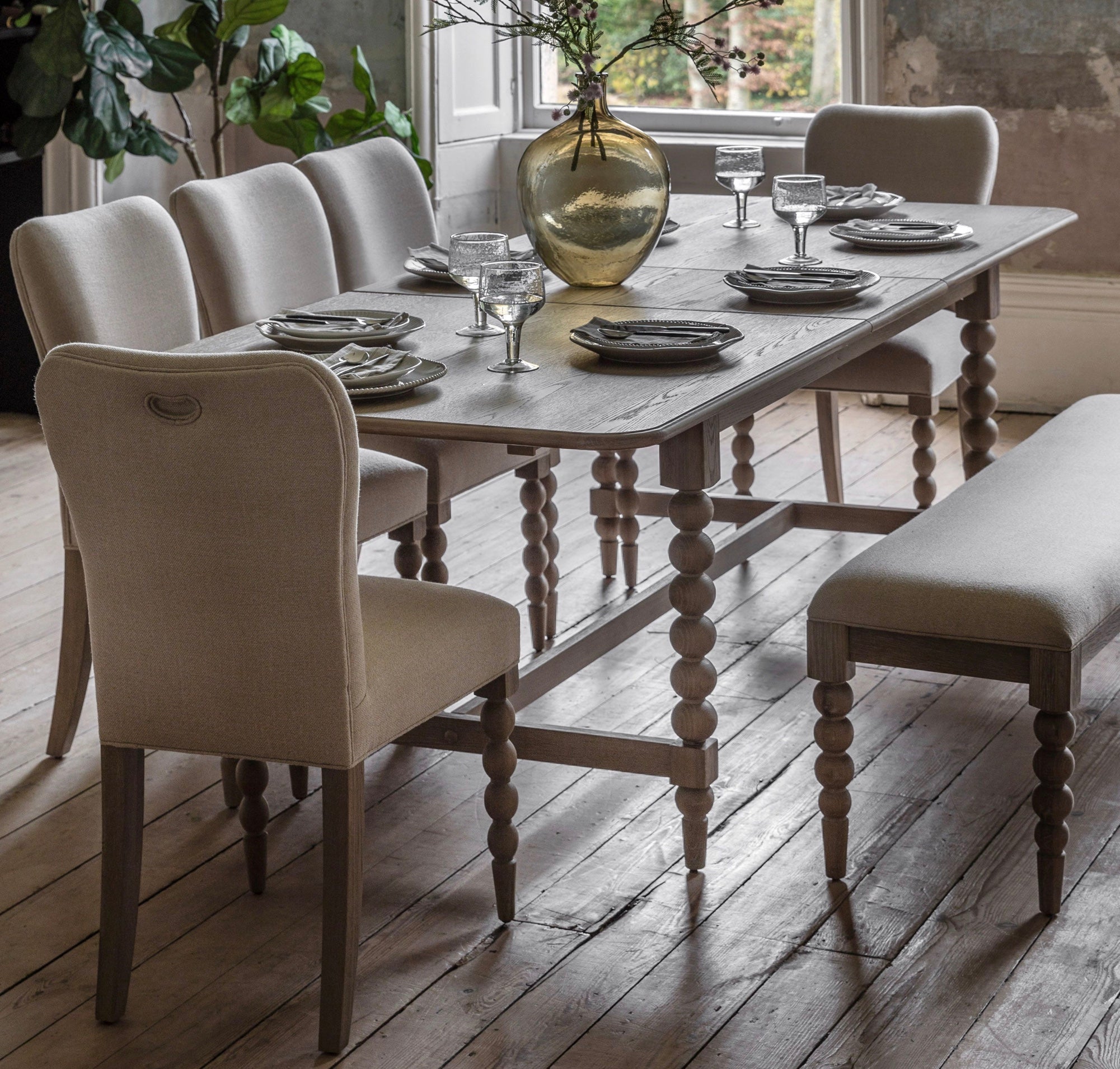 Light gray wooden dining table with turned spindles and distressed finish artisan lime rectangle wash oak extending dining table