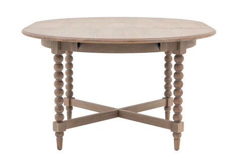 Artisan lime wash round oak dining table in light gray with beaded legs and x-shaped base perfect for dining areas