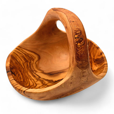 Artisan olive wood fruit basket with integrated handle smooth natural finish and distinctive swirling grain patterns
