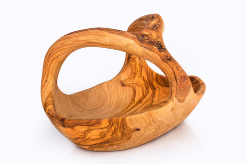 Handcrafted olive wood fruit basket with integrated handle and swirling golden-brown grain patterns perfect for serving