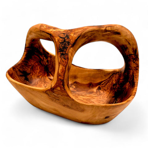 Handcrafted olive wood fruit basket with integrated handle featuring a warm amber finish and swirling grain patterns