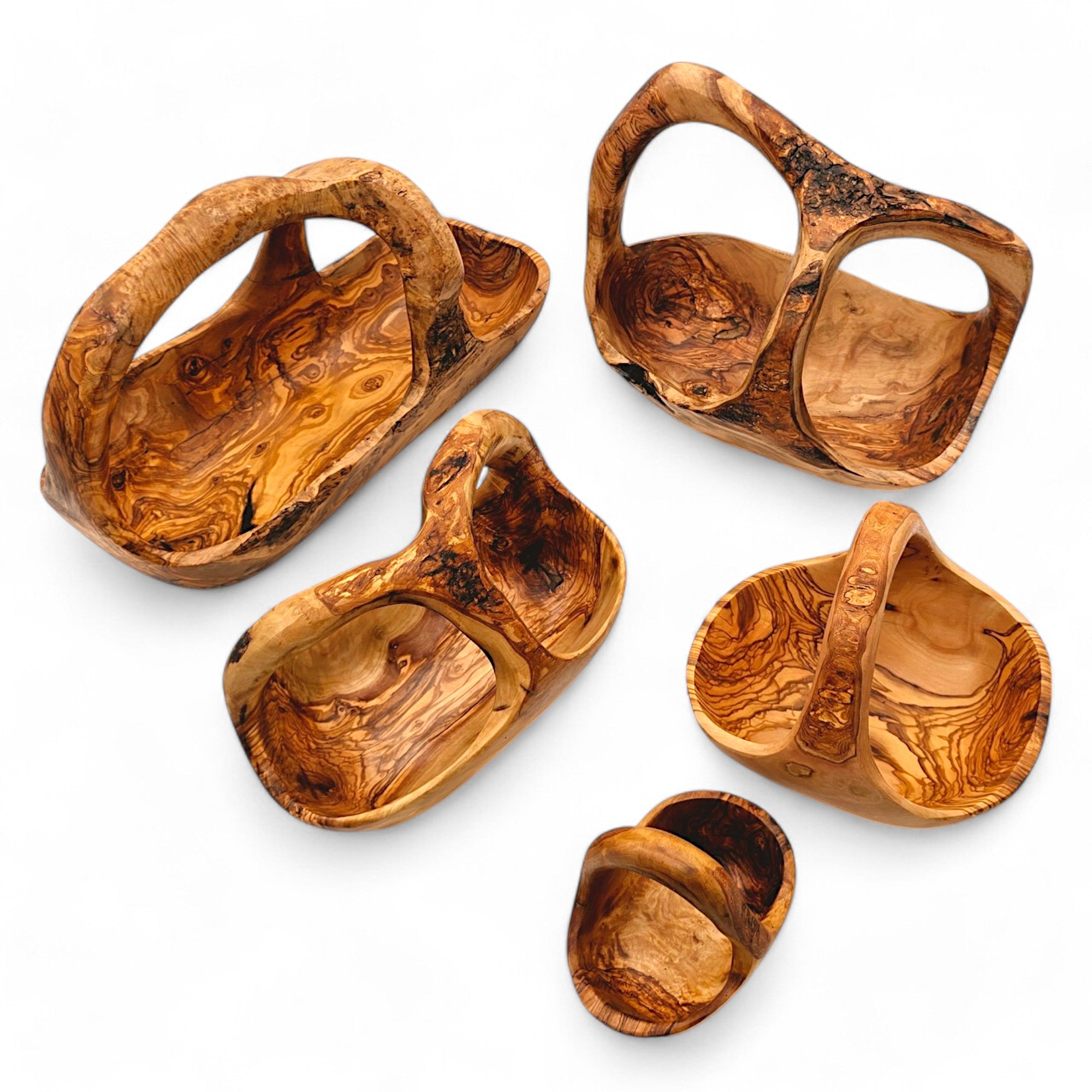 Handcrafted olive wood fruit basket with natural swirling grain patterns and rustic integrated handles for serving