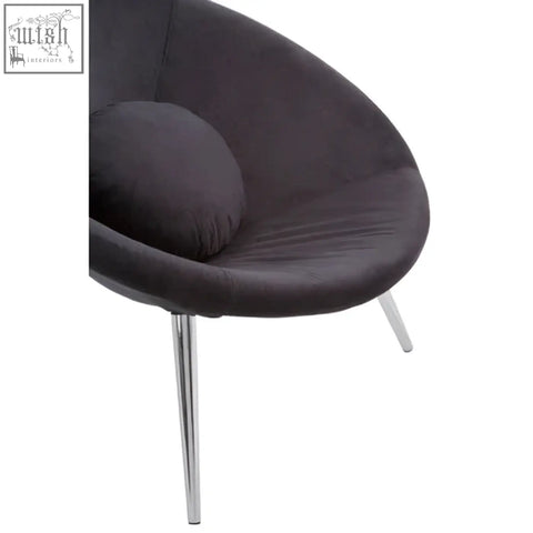 Dark gray velvet egg-shaped conic black chair with slender chrome legs perfect for modern living spaces