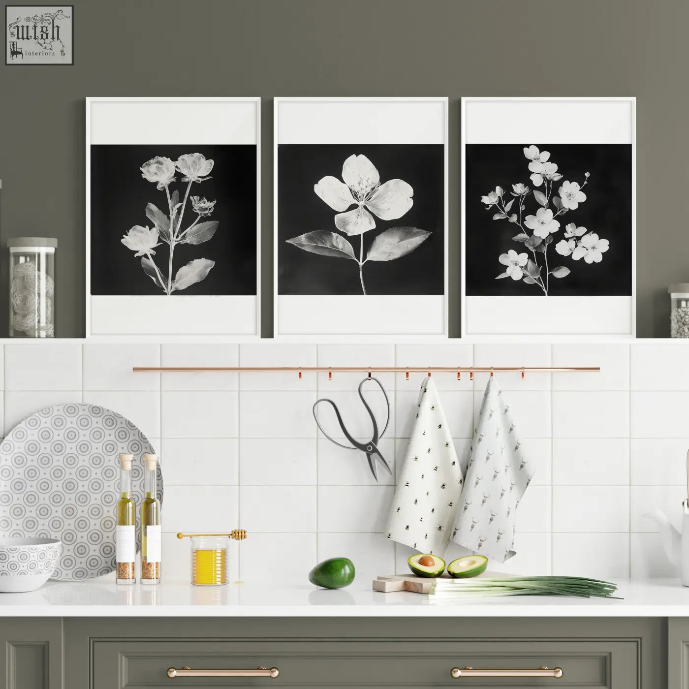 Three framed black and white floral art prints with white mats hang as kitchen wall decor above a counter