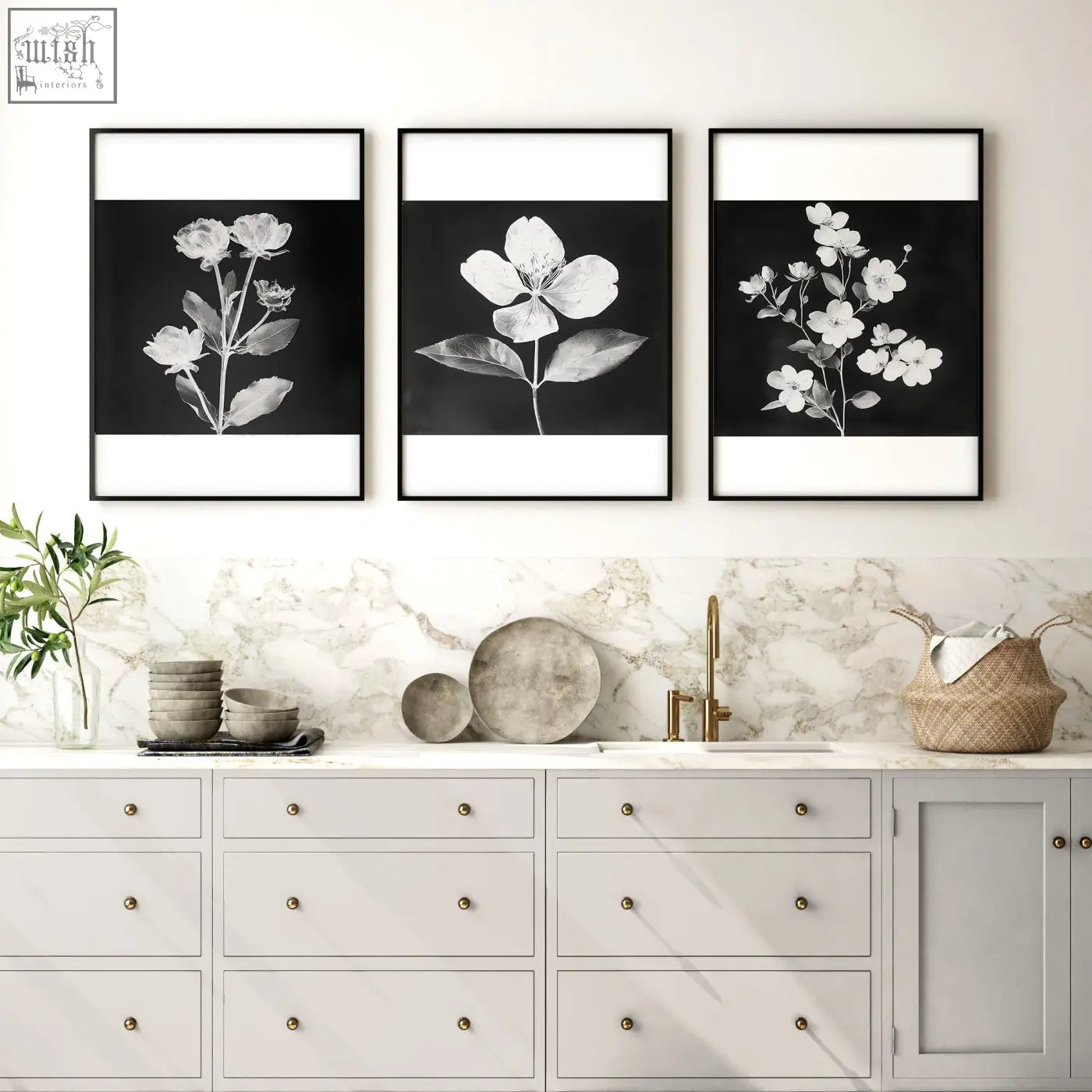 Three black and white botanical art prints in sleek black frames hanging as kitchen wall wall art above a marble countertop