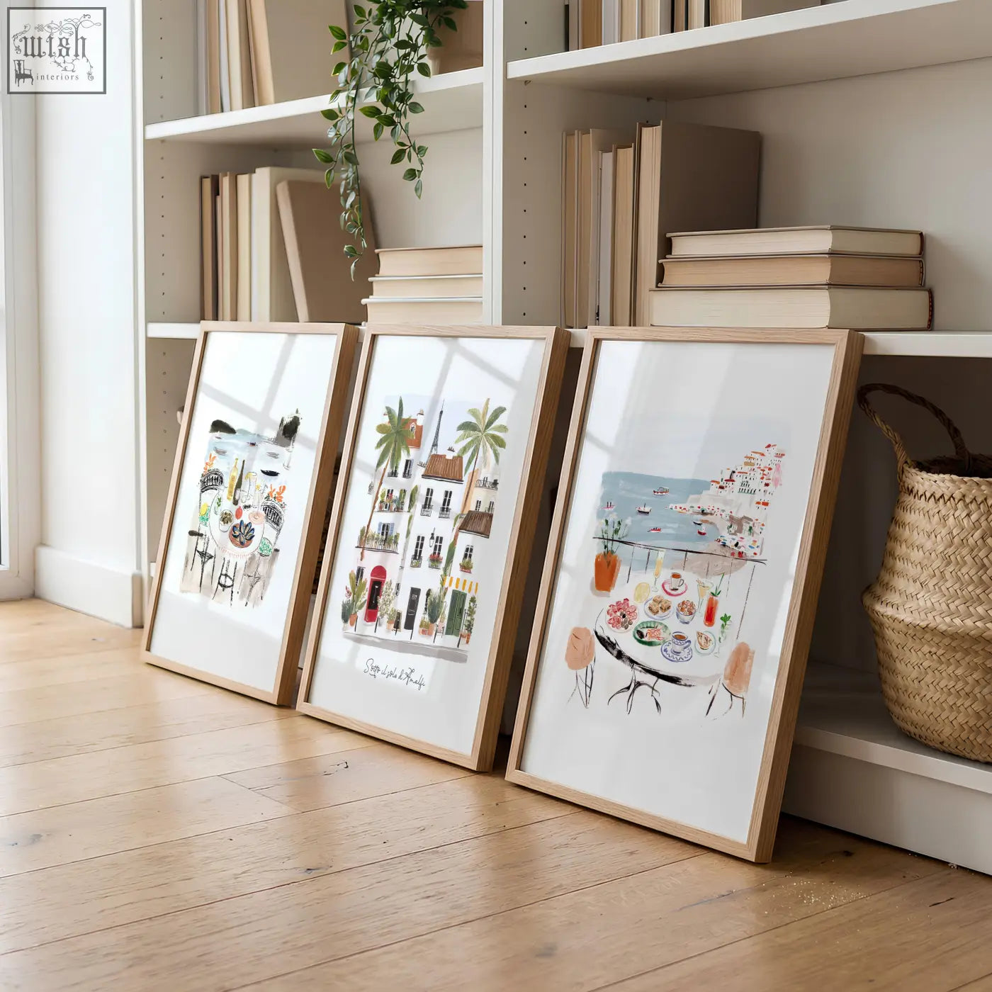 Three framed watercolor prints of seaside cafes with wooden frames leaning on a shelf for a living room sotto il sole di amalfi set