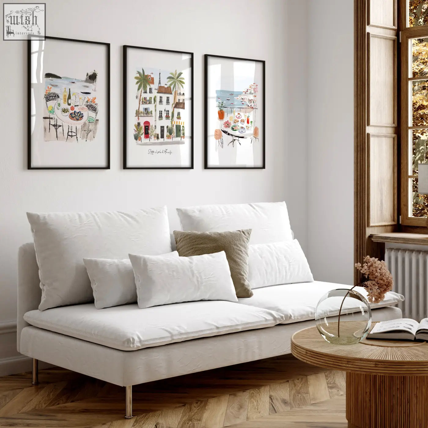 White upholstered sofa with metallic legs and cushions in living room featuring sotto il sole sole di amalfi artwork set