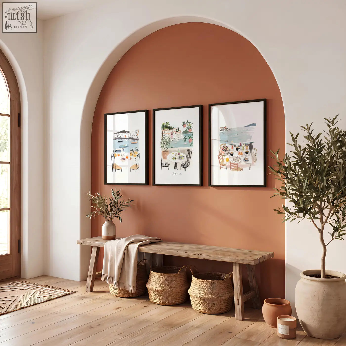 Three prints of mediterranean coastal scenes rustic wall art prints hang above wooden bench on terracotta wall