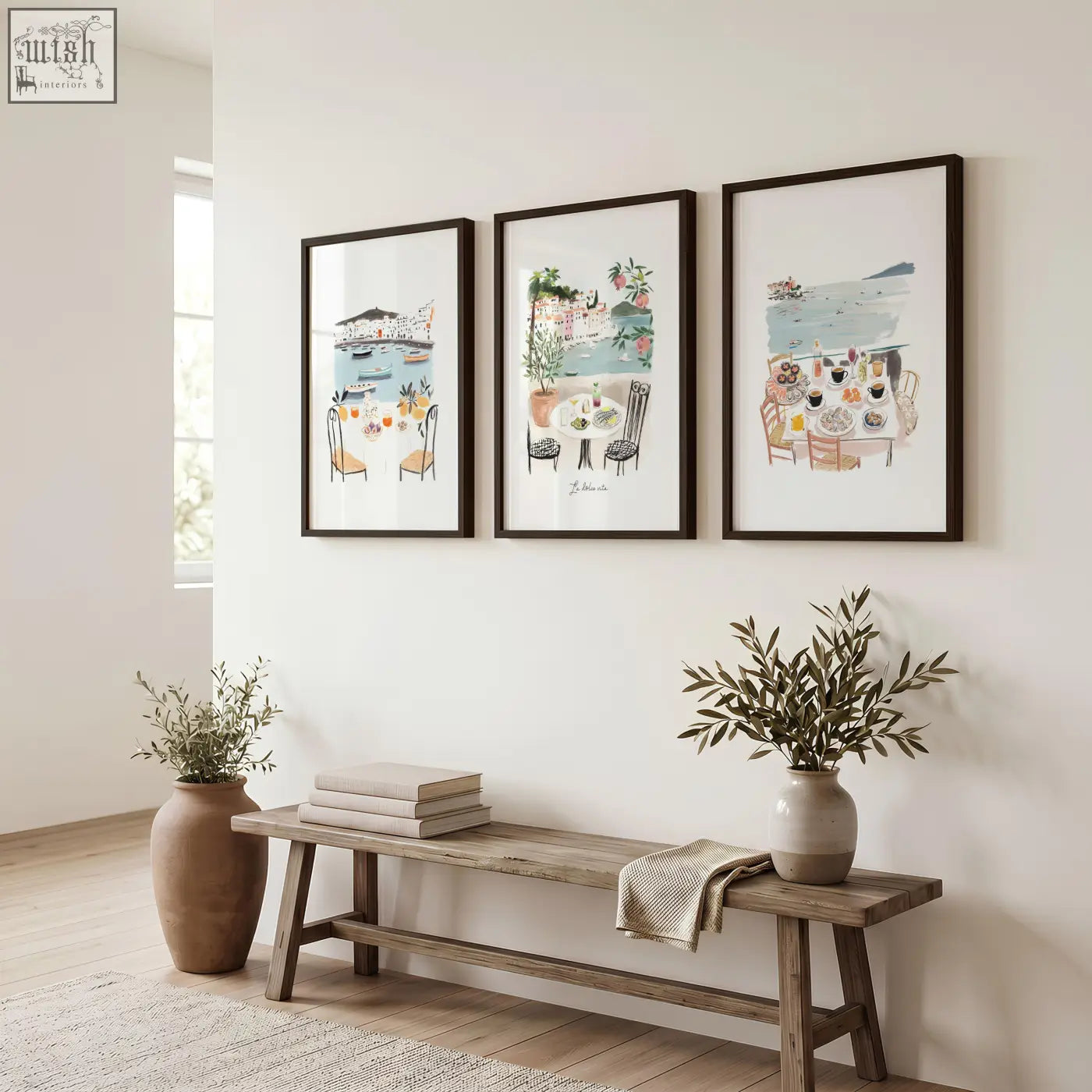 Three prints of watercolor coastal wall art prints in black frames above a rustic wooden bench for hallway decor