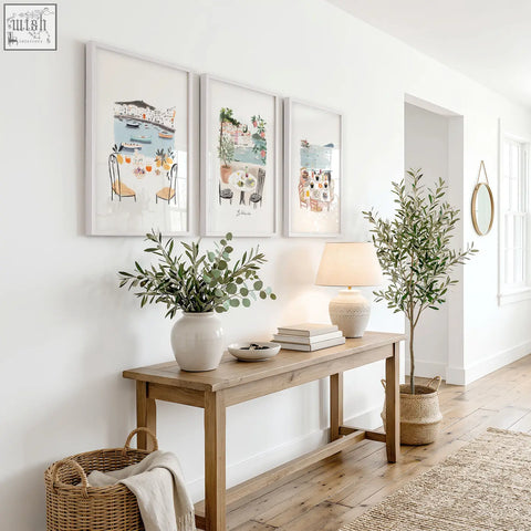 A rustic wooden console table with natural finish and simple legs below three prints wall art prints for hallway decor