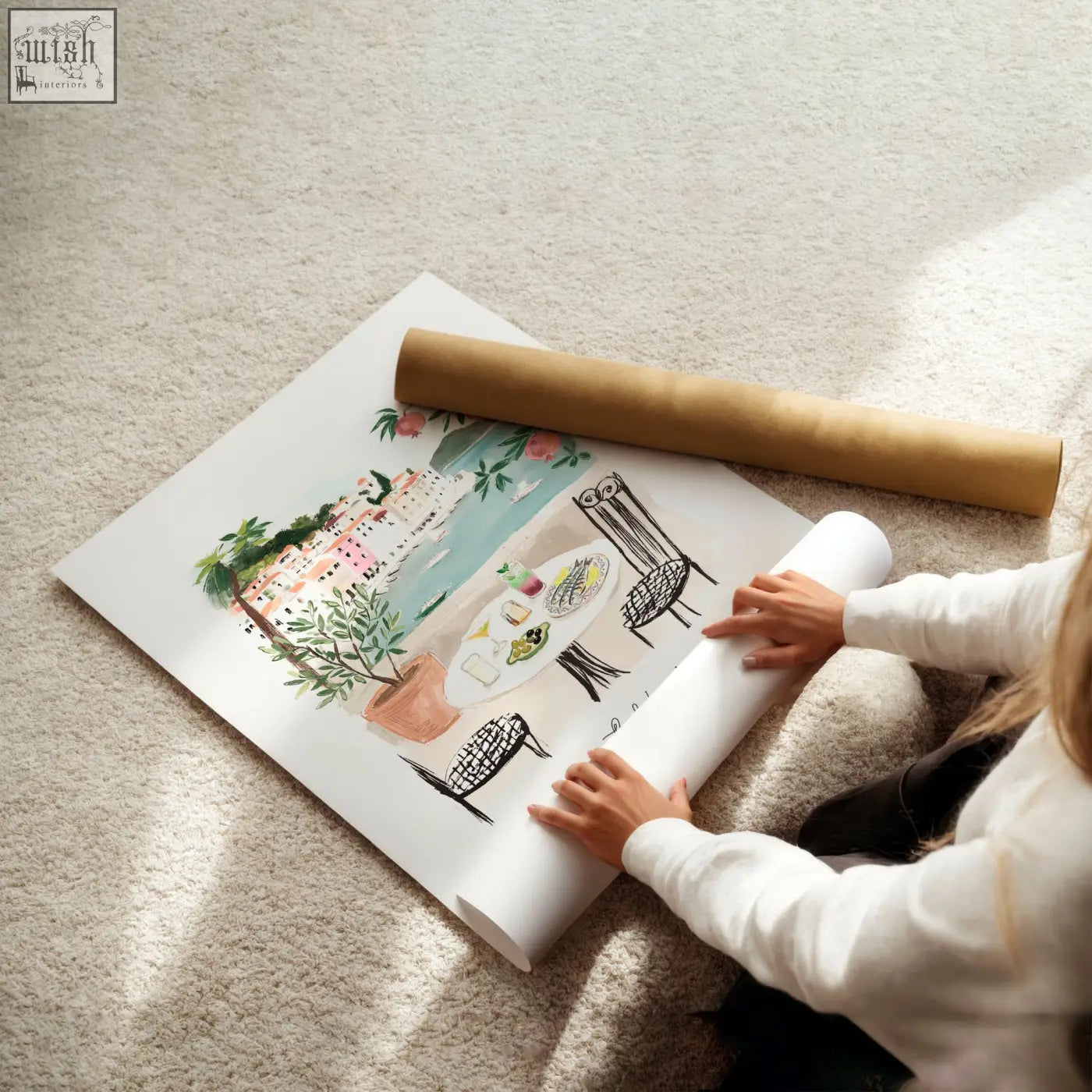 A rolled-up watercolor coastal scene poster with pastel buildings and greenery part of a three prints wall art set