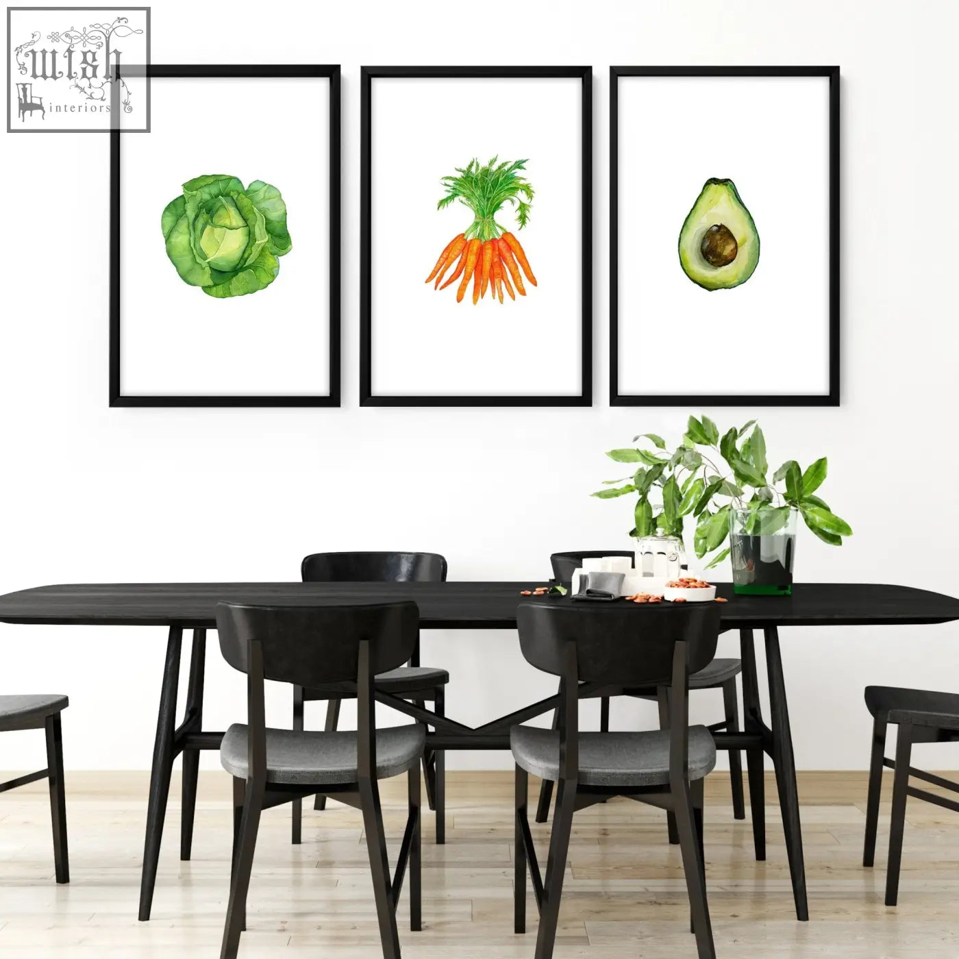 Three black-framed watercolor prints of green cabbage, orange carrots, and halved avocado for kitchen decor wall art