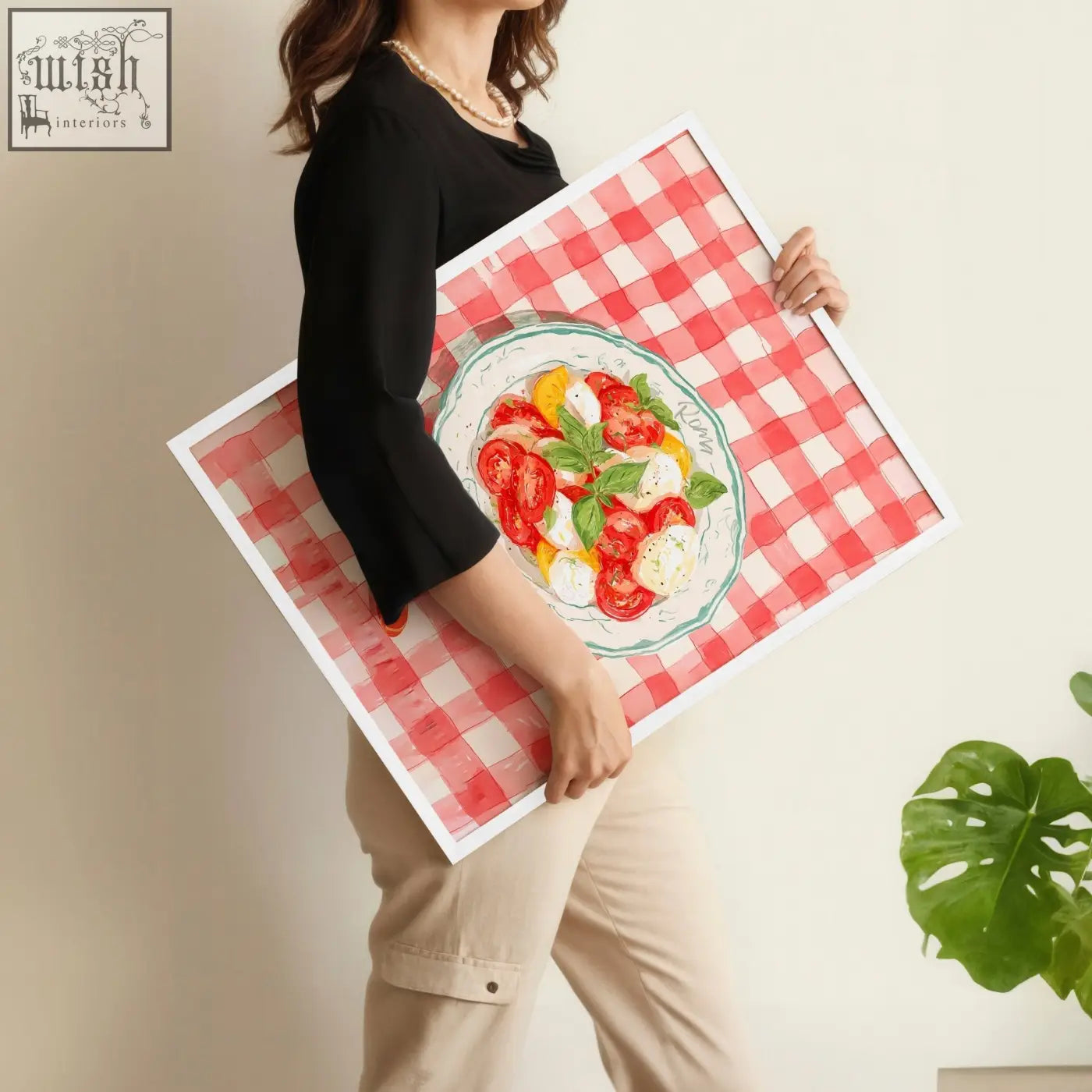 A framed kitchen wall art with vibrant watercolor caprese salad on white plate and red white checkered background