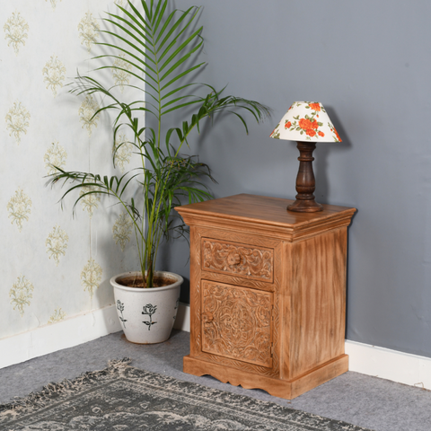 Carved artwork mango wood bedside table with storage featuring warm finish and intricate floral patterns