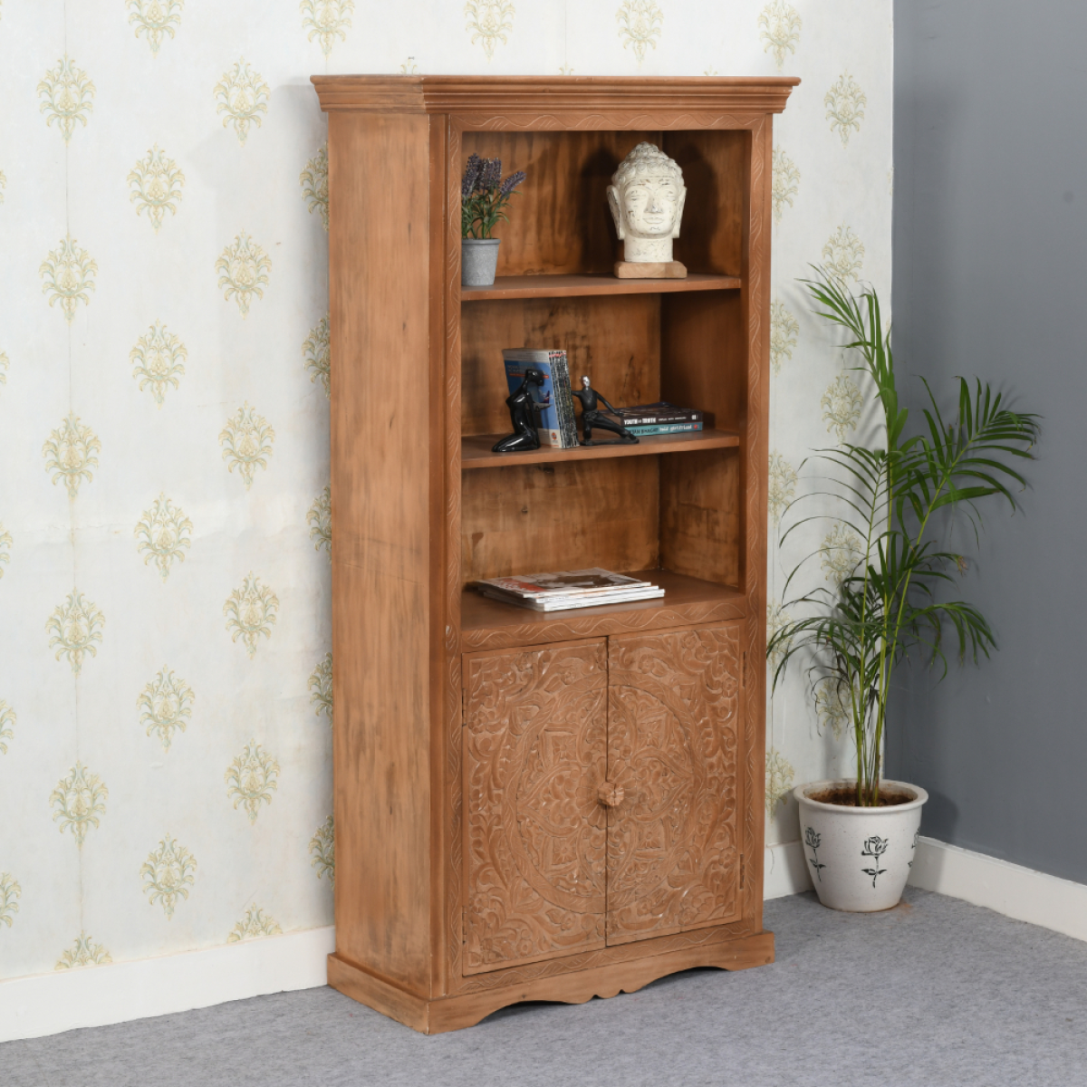 A rustic artwork mango large bookcase in warm natural finish with intricate carvings on mango wood cabinet doors